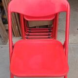 Red designer folding chairs from the 70s