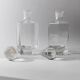 Lot of vintage 1970s consisting of 2 hexagonal glass carafes, transparent glass with spherical stoppers.