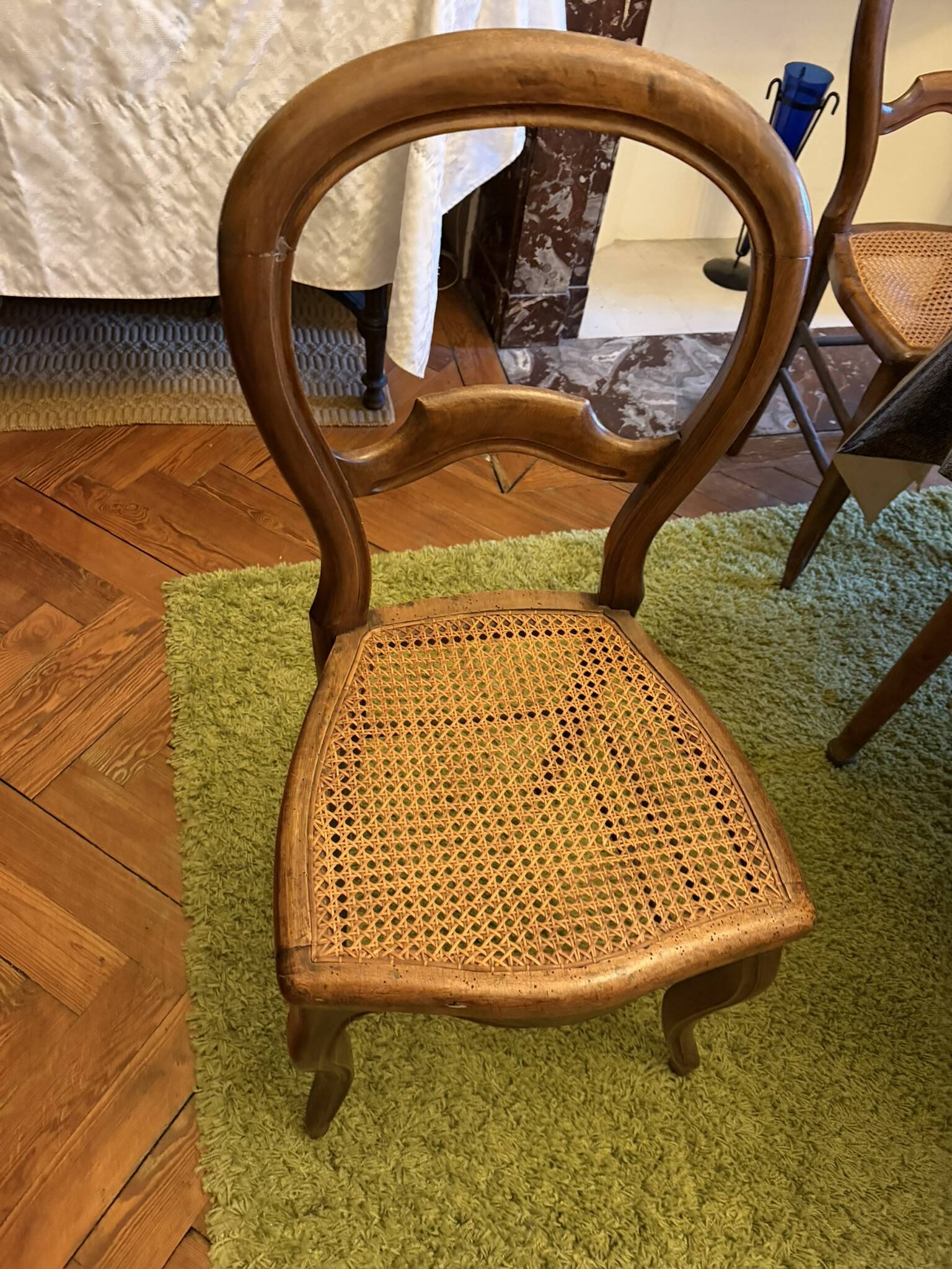 Light medallion chairs and carved fruit chairs.
