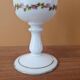 Footed glass in the shape of a chalice in white opaline with a floral decoration.