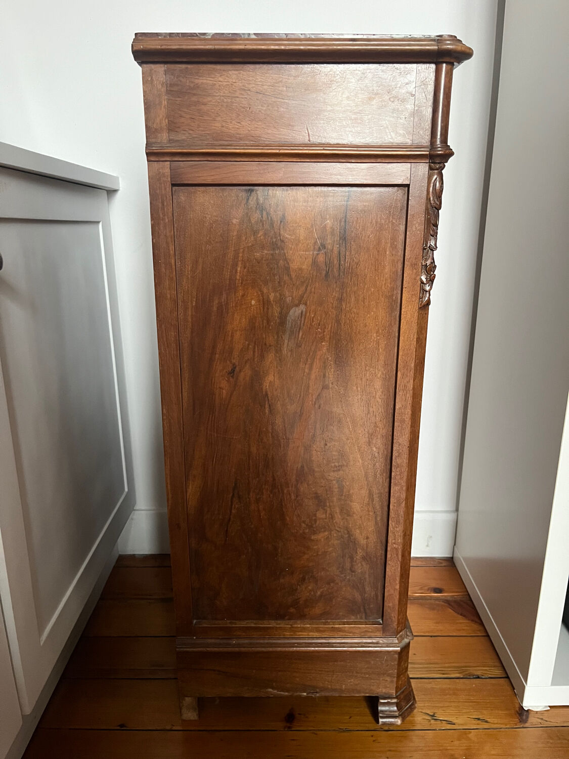 Solid wood storage furniture with a marble top.