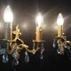 Pair of gilt bronze wall sconces with crystal pendants.