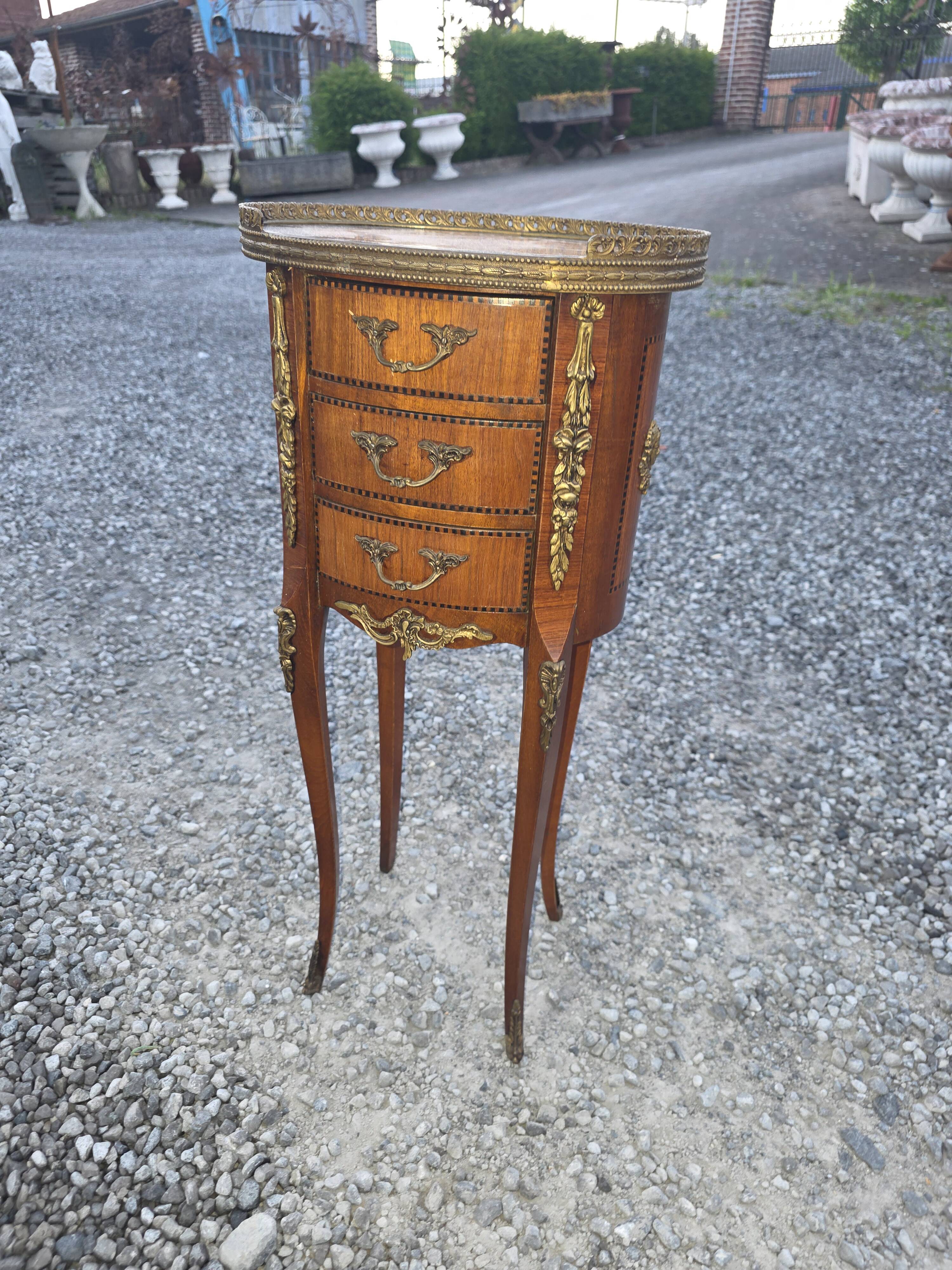 Oval bedside table in Louis XV style with marquetry.