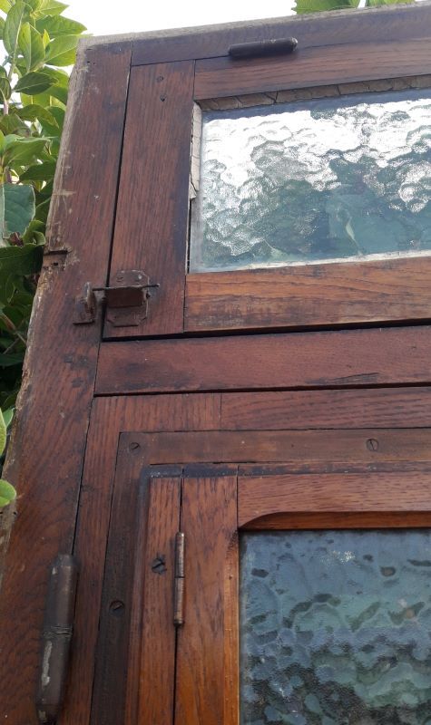 Oak entrance door and its frame and transom, wrought iron gates