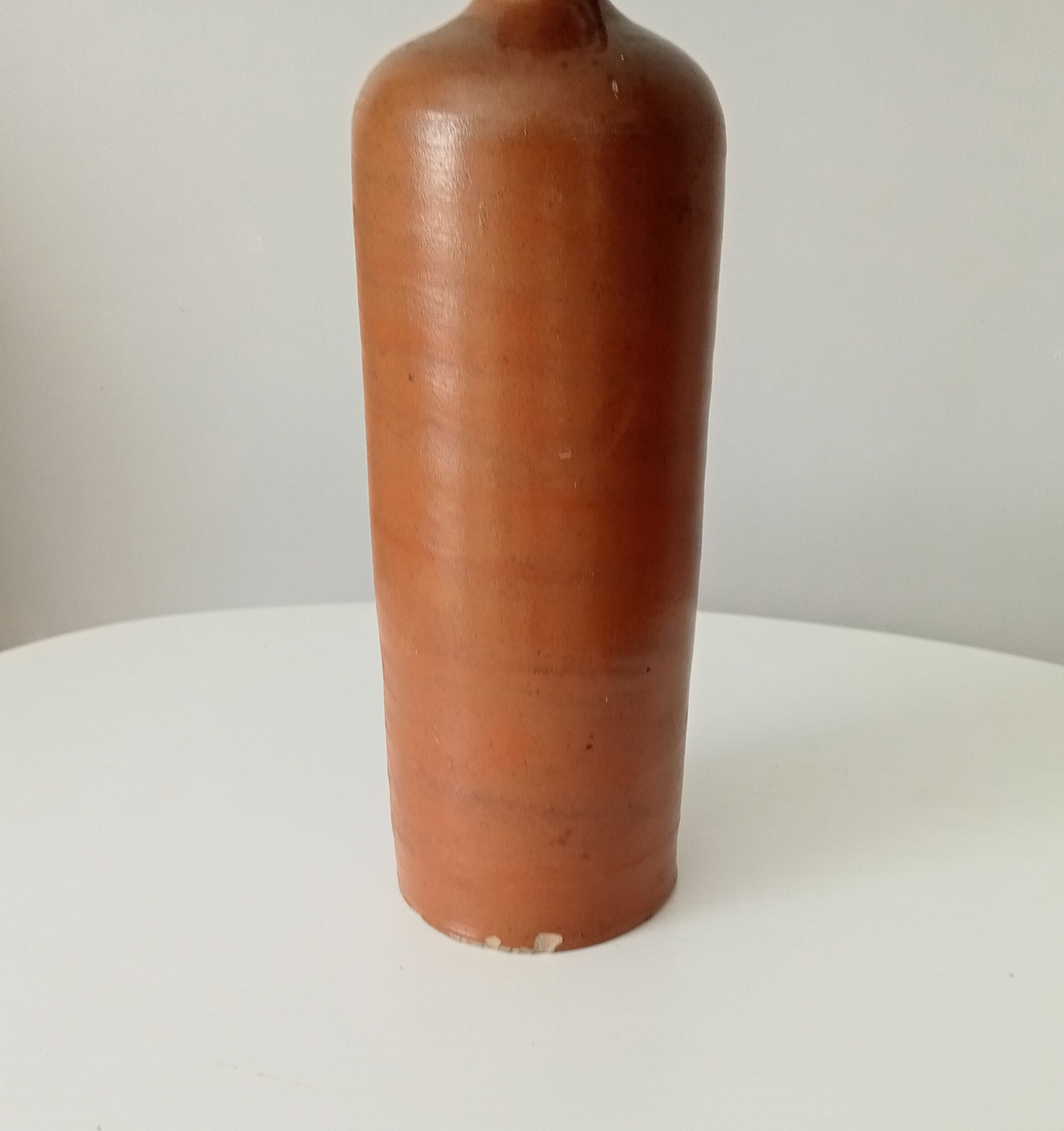 Old bottle in glazed sandstone