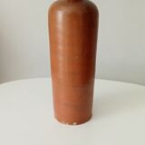 Old bottle in glazed sandstone