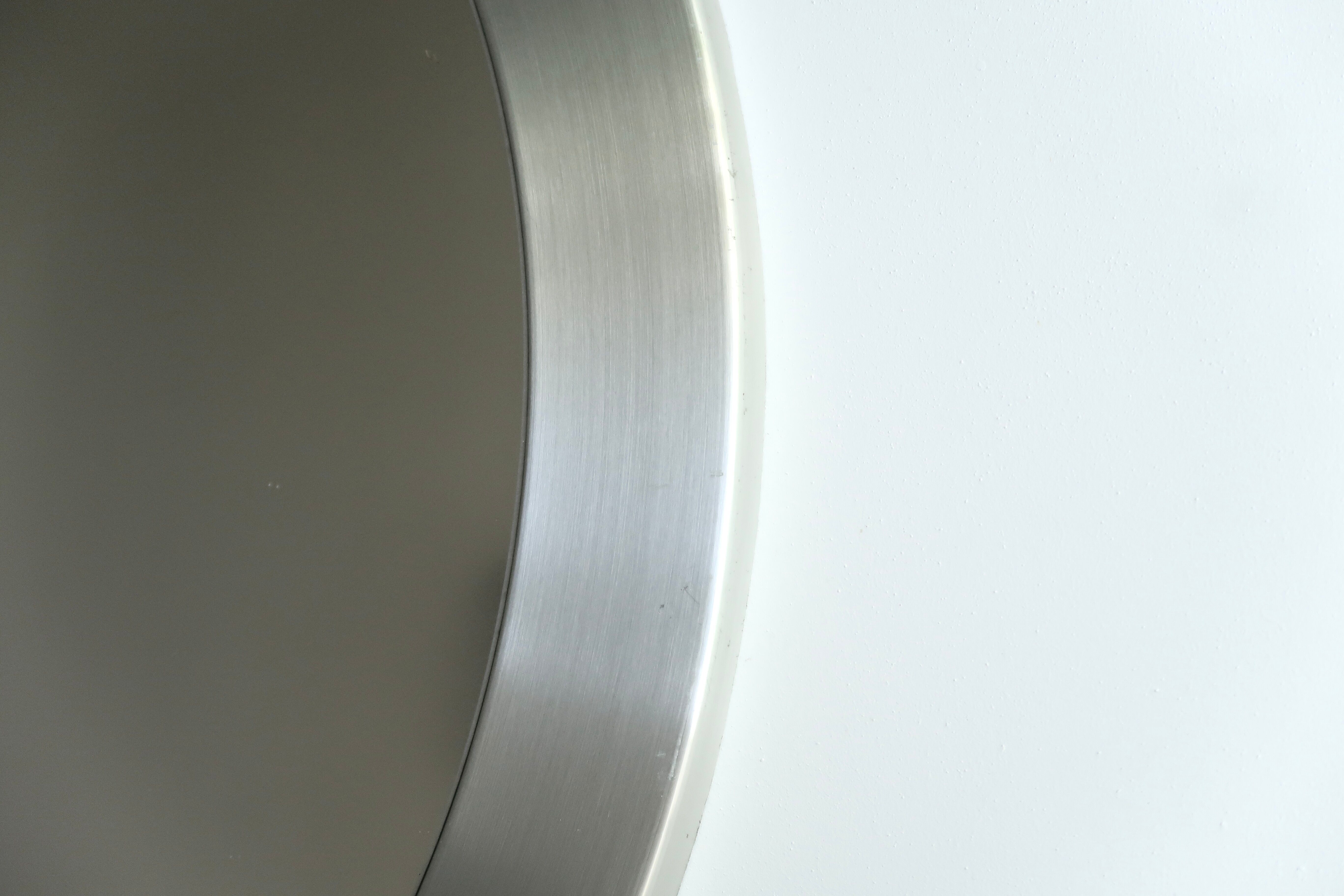 Round brushed aluminium mirror, 1970s