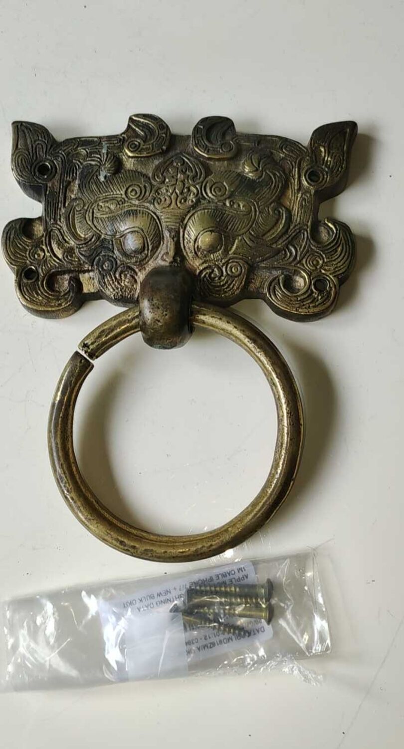 Ancient door knocker, taotié mask, shang dynasty. in bronze golden patina