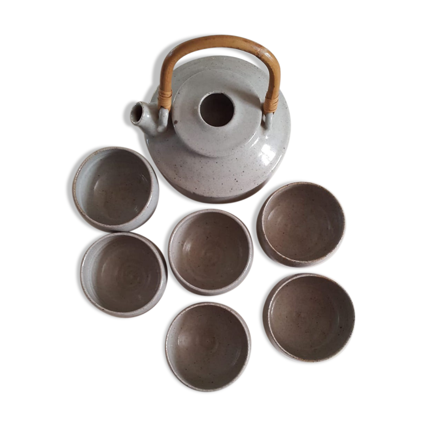 Set of sandstone teapot with rattan handle and six bowls from the 70s