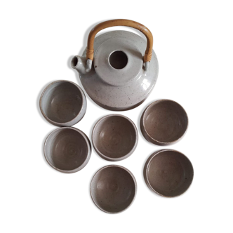 Set of sandstone teapot with rattan handle and six bowls from the 70s