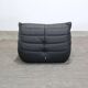 Togo armchair and footrest in black leather by Ligne Roset, designed by Michel Ducaroy.