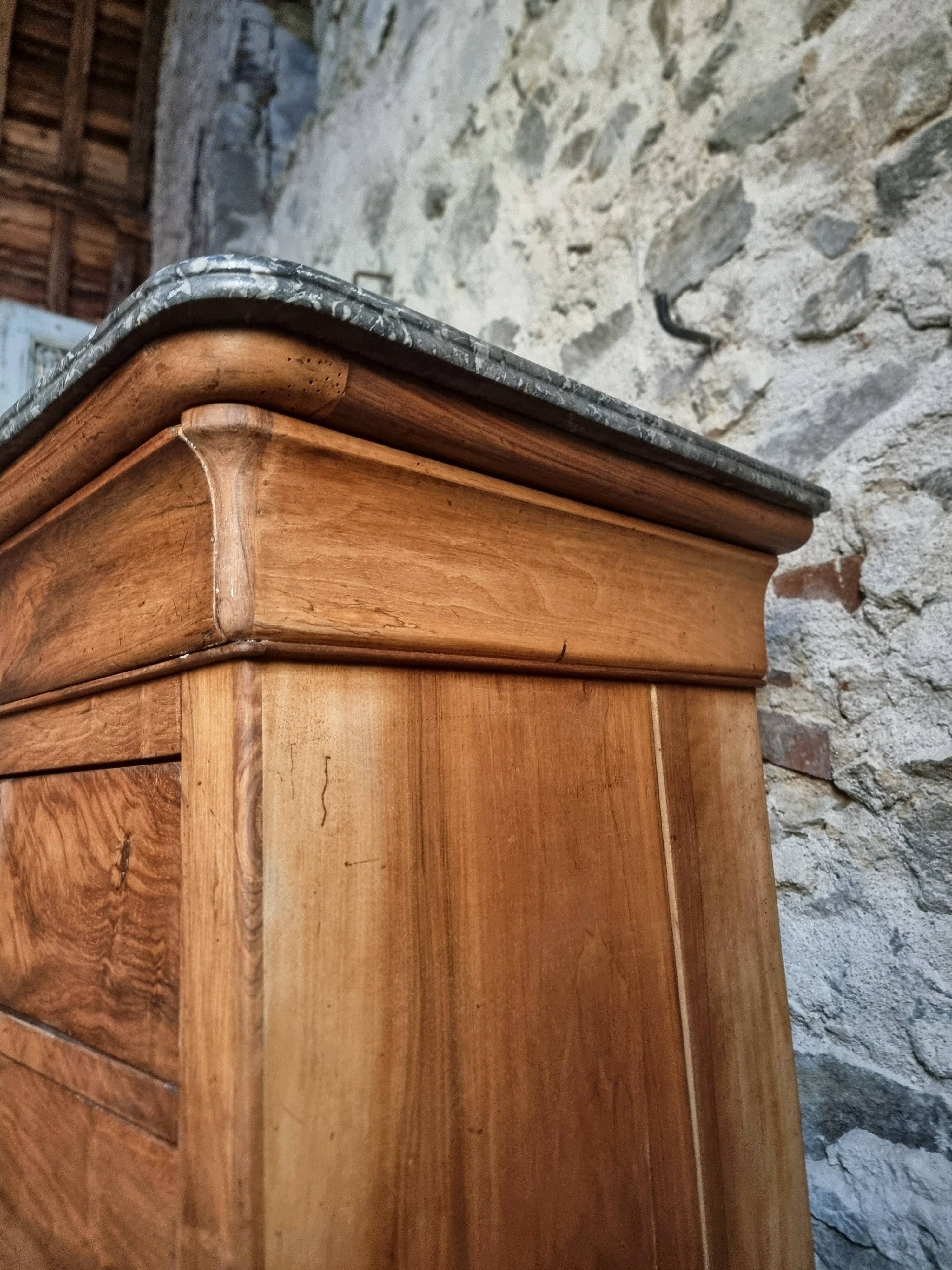 French antique walnut commode with a dark grey marble top, circa 1830–1860.