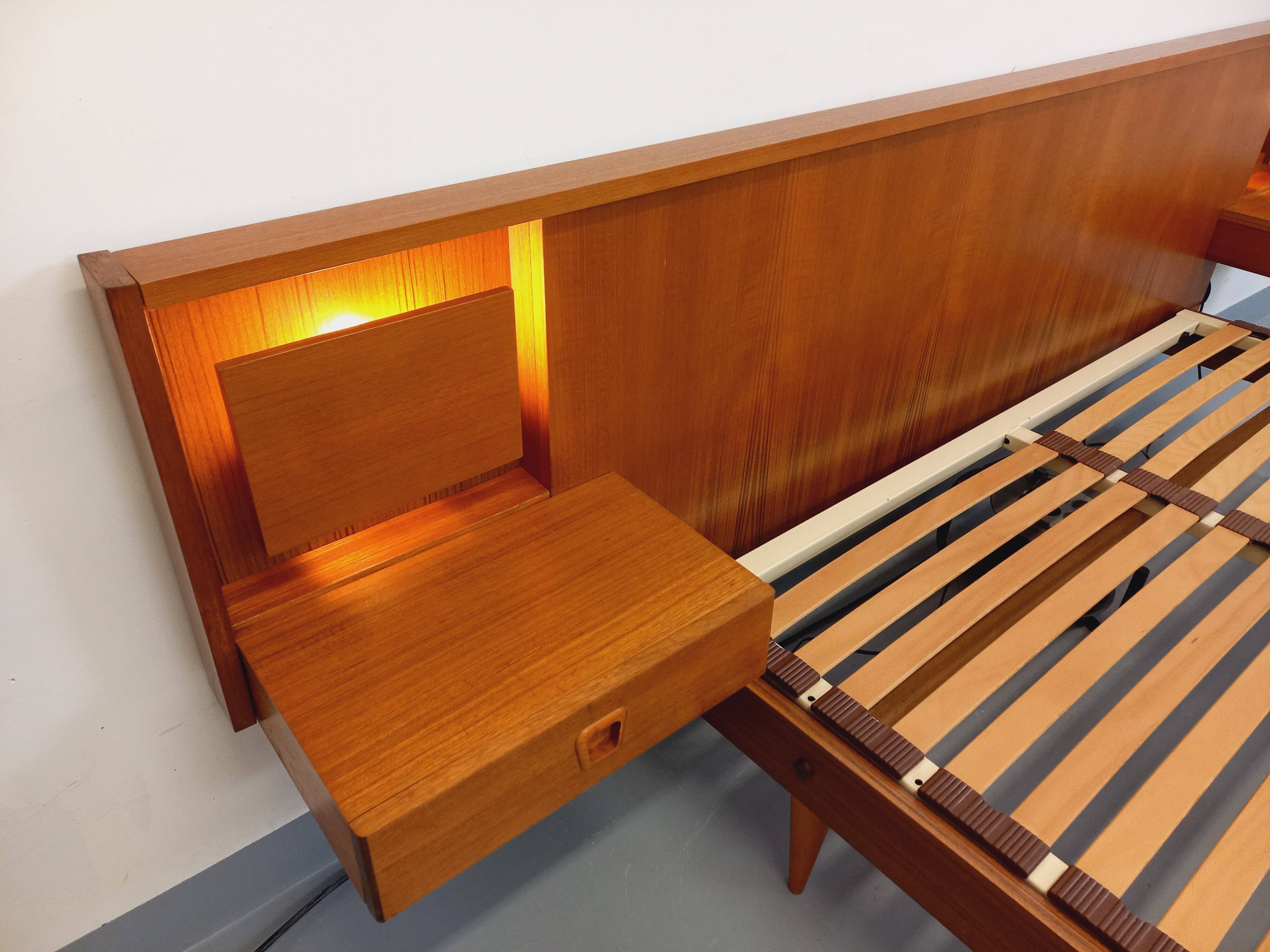 Double bed in vintage Scandinavian style from the 1960s with bedside tables in teak.