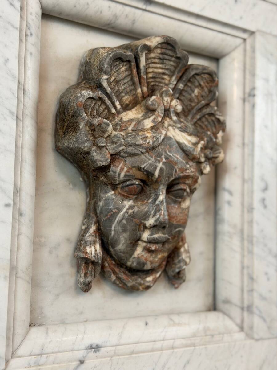 Female mascaron in grey Ardennes marble from the Regency period, 18th century.