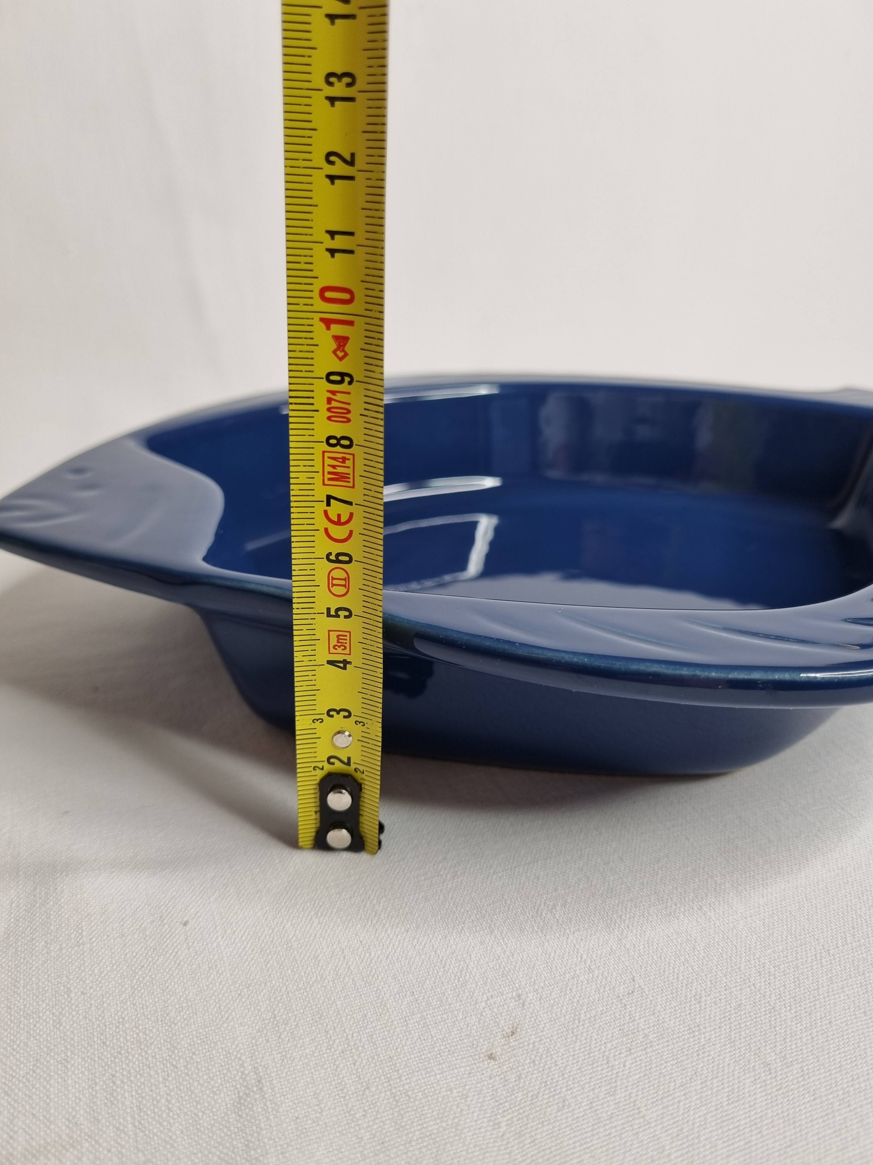 Blue ceramic serving dish in the shape of a fish signed Émile Henry