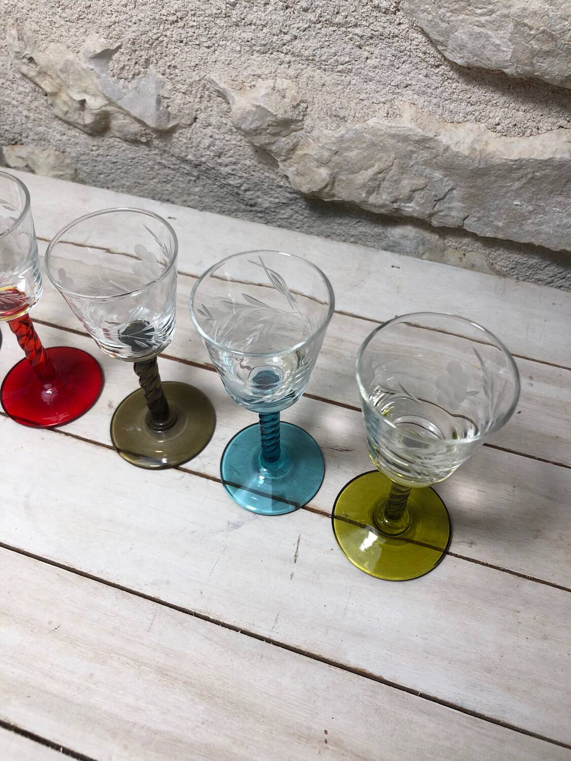 Antique and rare! Sold in a set of 12 colorful twisted stemmed glasses engraved with flowers and leaves