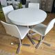 Extendable round table in white formica and 4 matching chairs by Roche Bobois.