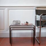 Vintage trio of nesting tables in smoked plexiglass by Michel Dumas, year.