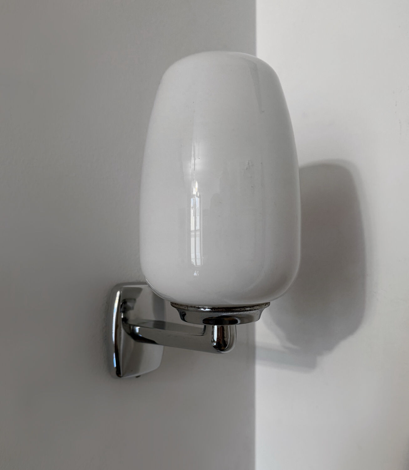 Chrome and opaline wall lights from the 70s.