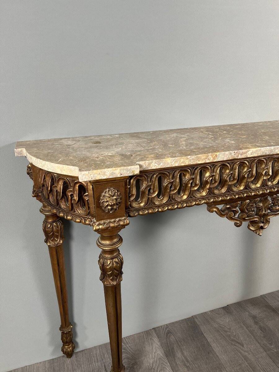 Louis XVI style console in carved wood with a gilded patina, 19th century.