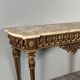 Louis XVI style console in carved wood with a gilded patina, 19th century.