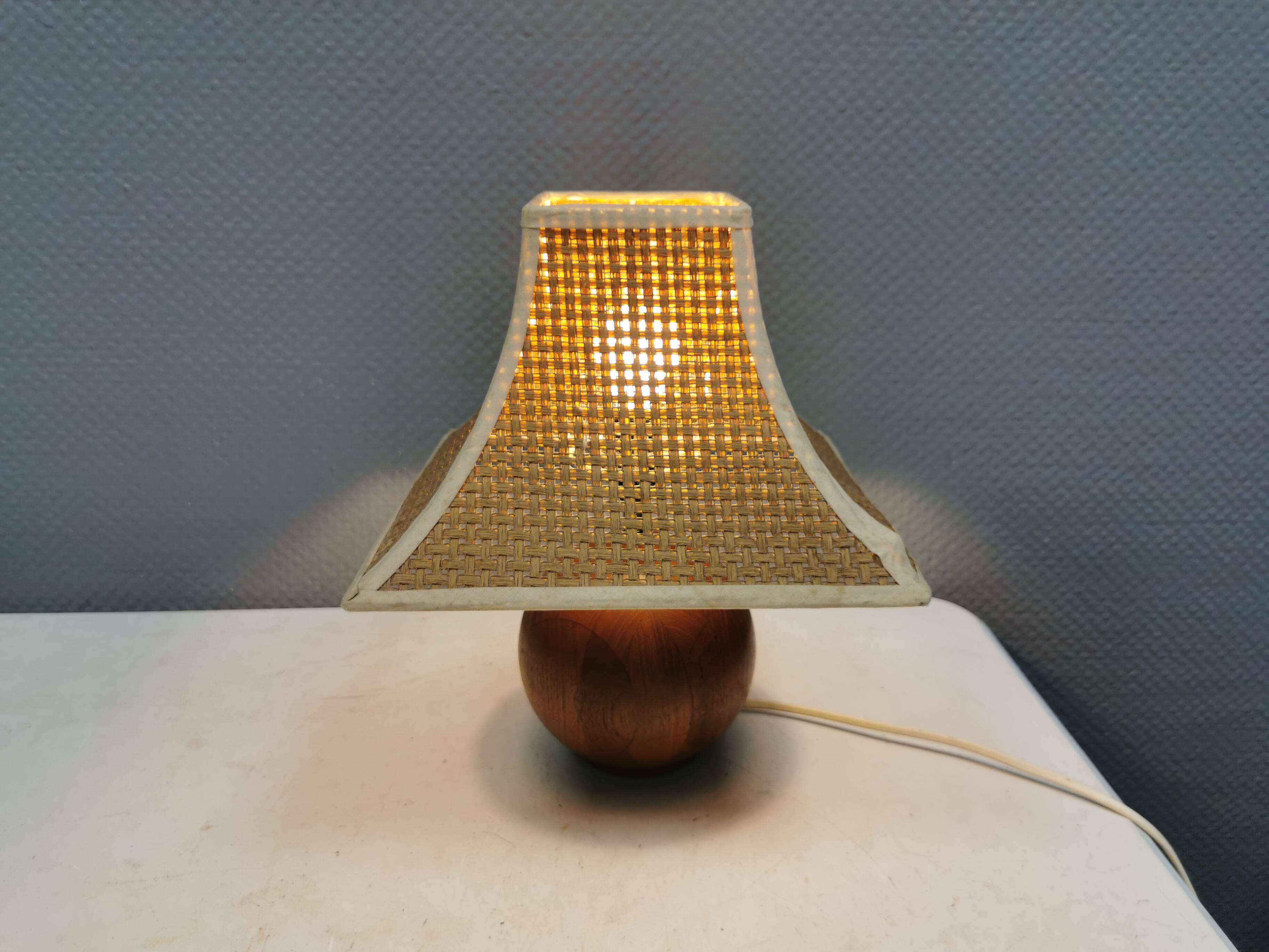 Very rare table lamp in turned teak wood with original braided shade. 1970s
