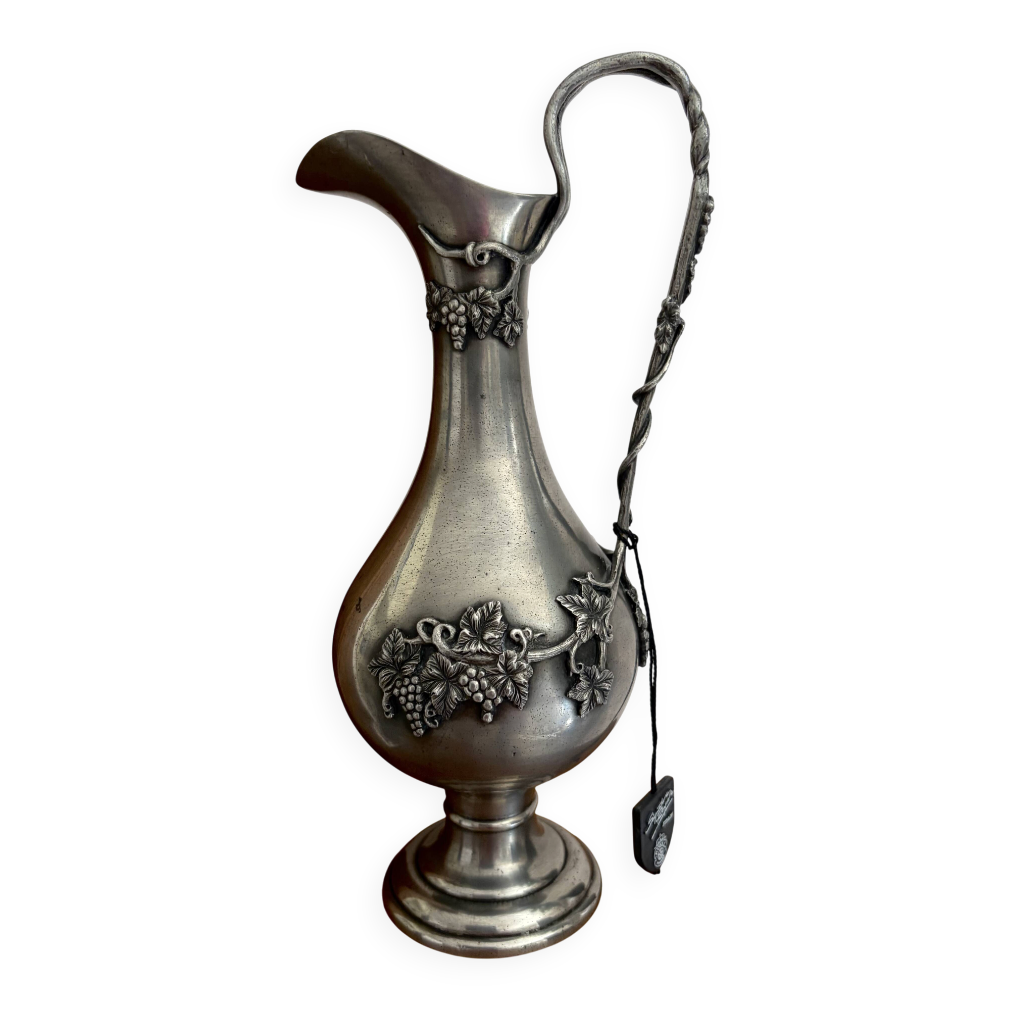 Ewer in pewter surrounded by vine branches with g