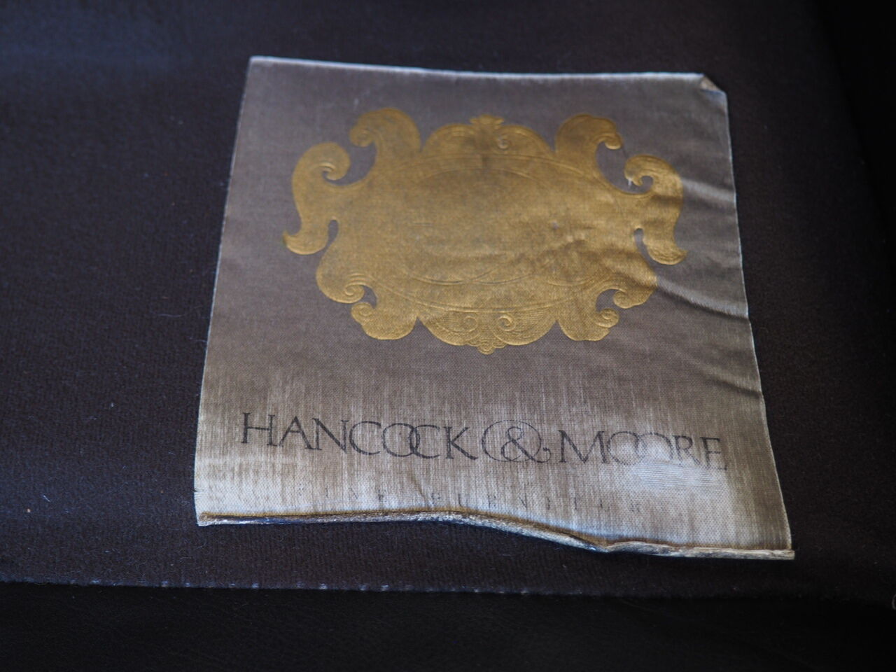 Chesterfield style leather armchair & footstool by Hancock & Moore