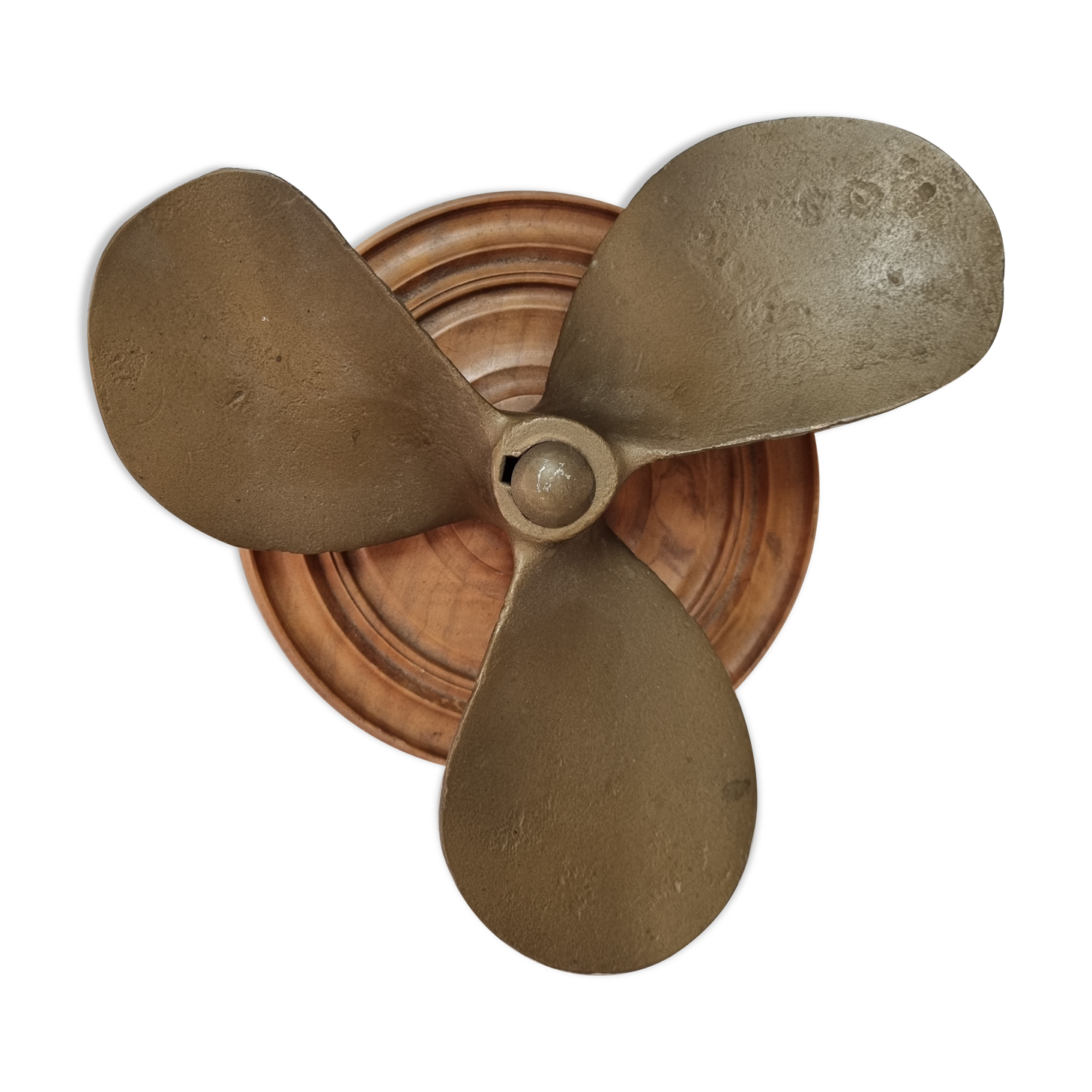 Bronze boat propeller on wood