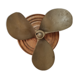 Bronze boat propeller on wood