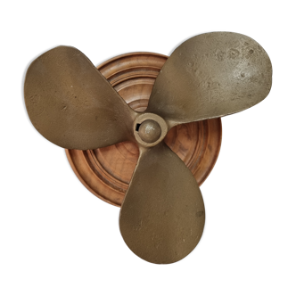 Bronze boat propeller on wood