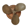 Bronze boat propeller on wood