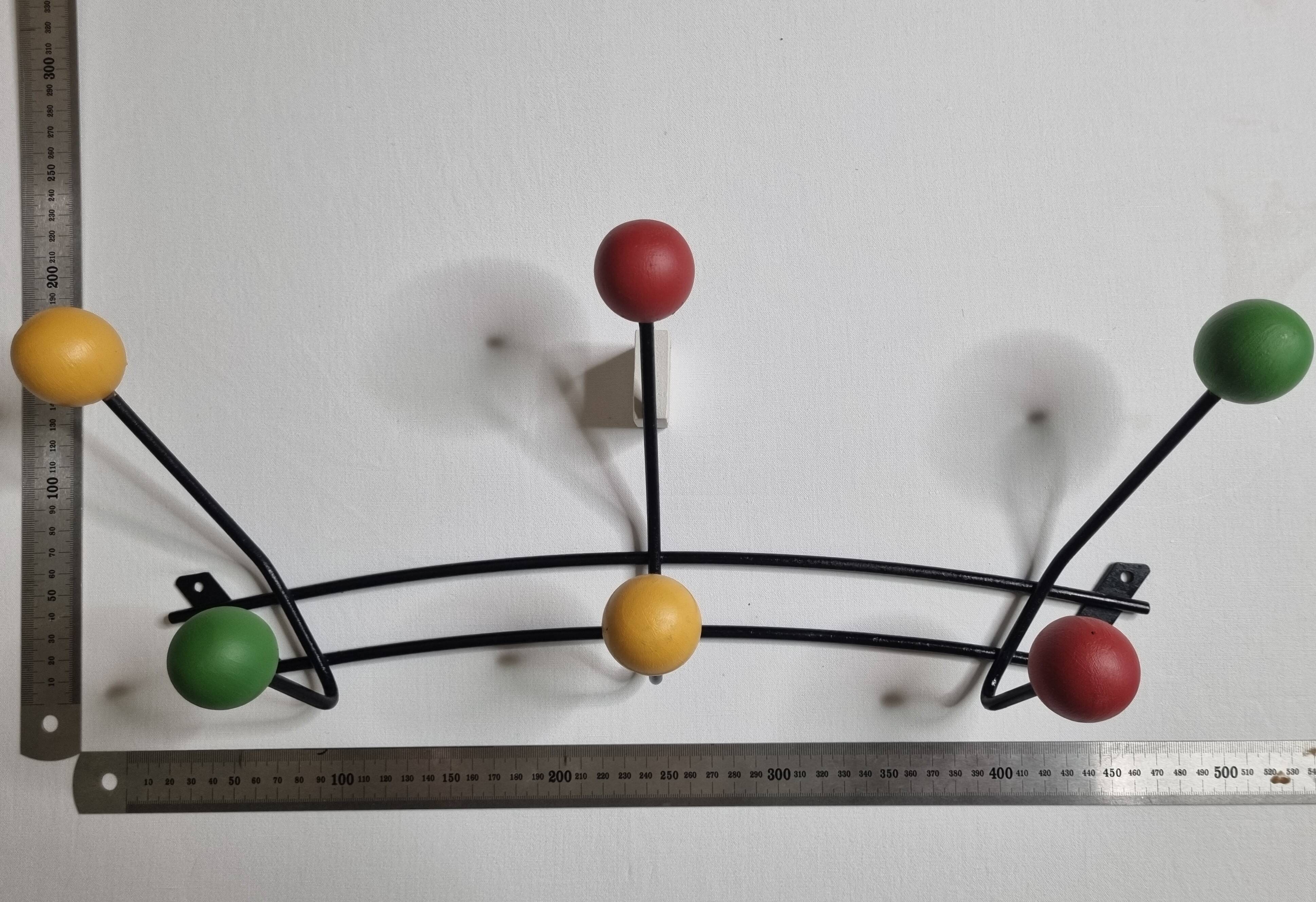 Vintage wall coat rack in black metal and wood, Roger Féraud style from the 1960s.