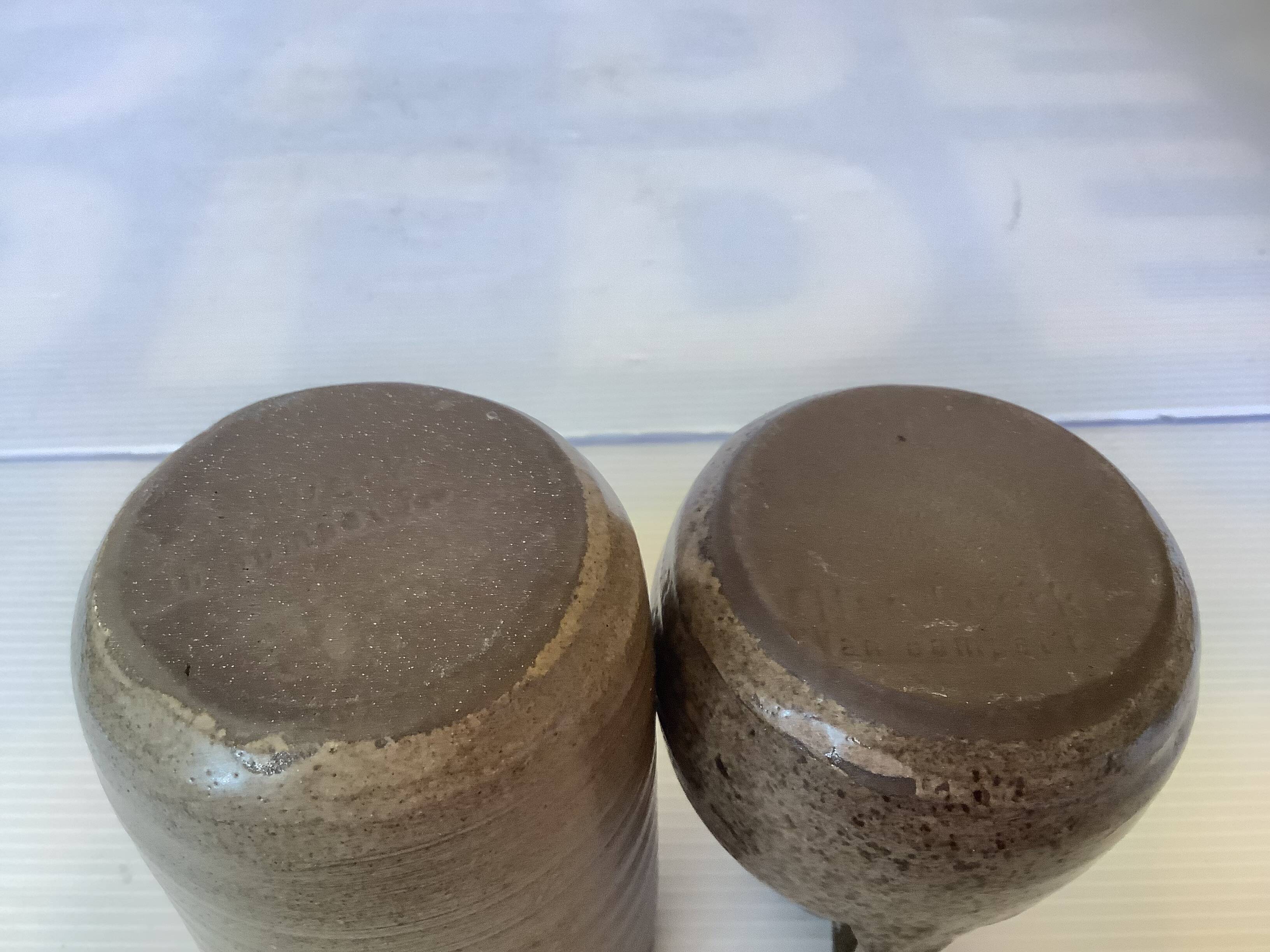 Eight brown ceramic pitcher vases