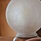 White glass globe table lamp with geometric reliefs