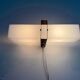 Simple white plexiglass wall light with a black metal frame, 1970s, Germany.