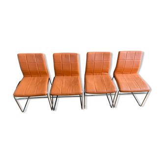 Four orange and chrome vintage chairs