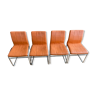 Four orange and chrome vintage chairs