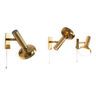 Set of three brass adjustable wall lamps