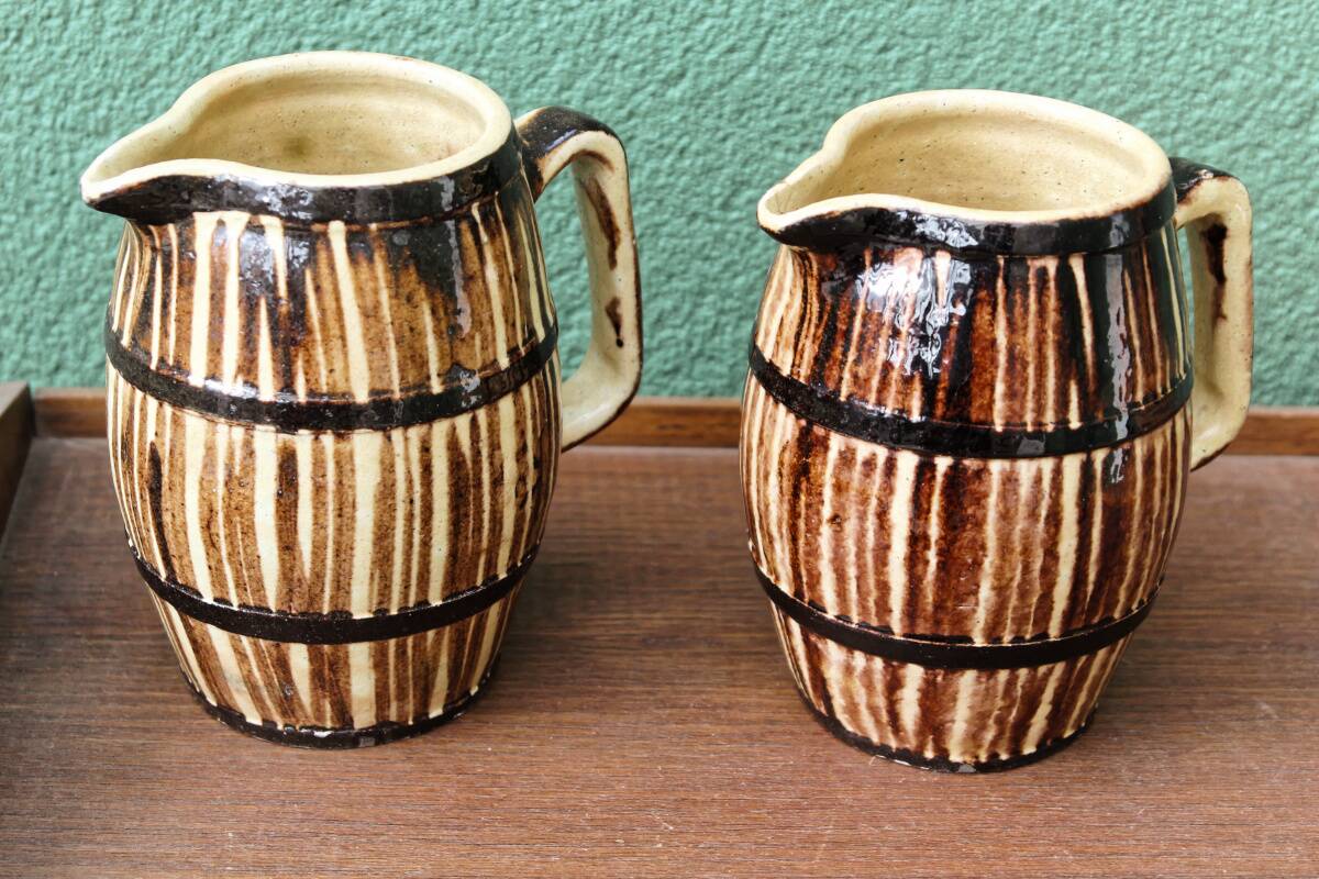 Pair of trompe l'oeil bistro pitchers, barrels