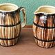Pair of trompe l'oeil bistro pitchers, barrels