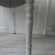 Walnut table with raised flaps, base on verdigris casters.