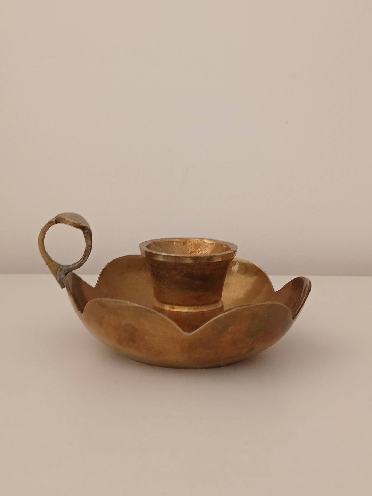 Brass candle holder in the shape of a flower.
