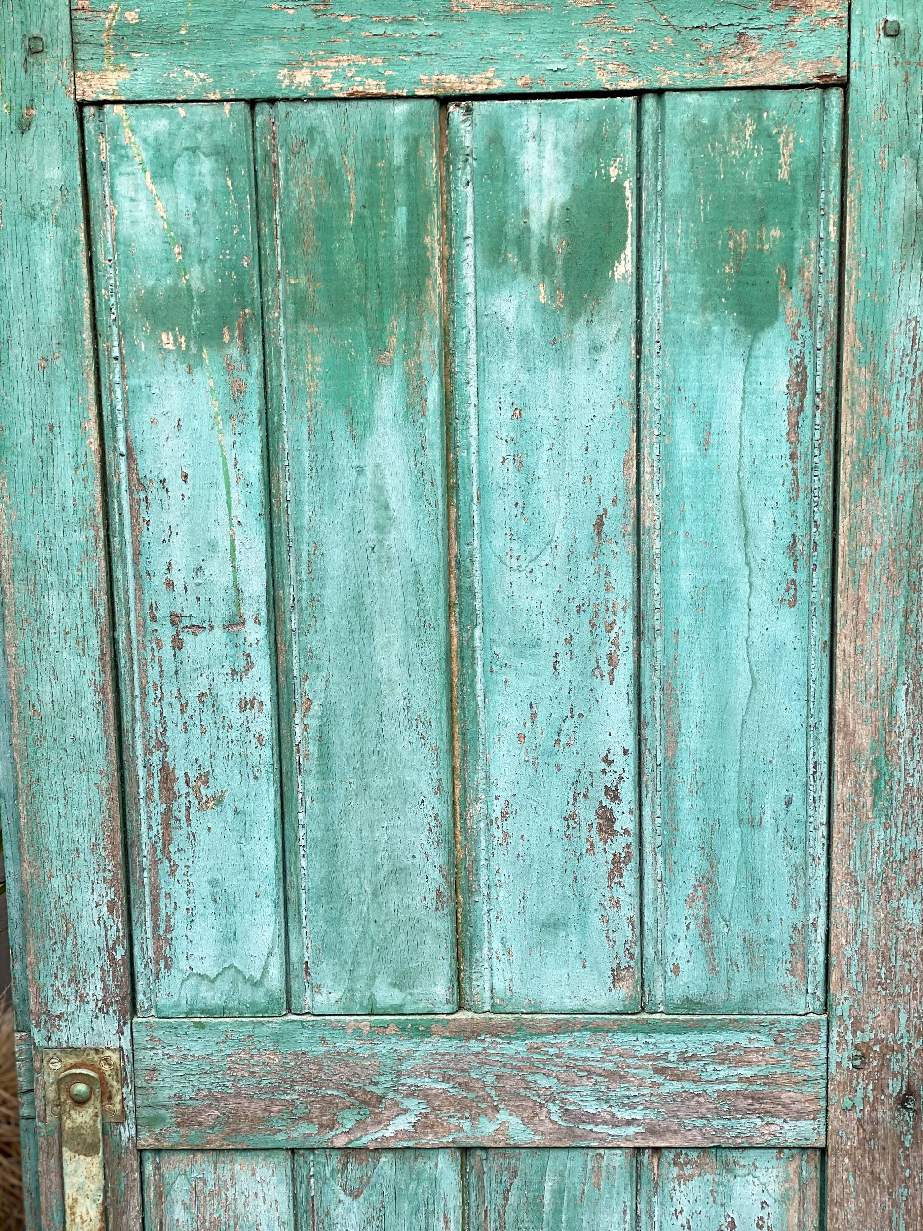 Pair of old wooden shutters green mint color