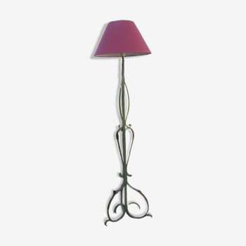 Old wrought iron floor lamp with its lampshade on 3 feet