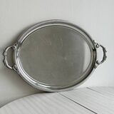 Large stainless steel serving platter with fish-shaped handles.