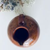 Old pitcher in glazed terracotta