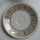 Solitaire tea cup, saucer, and dessert plate in white and gold.