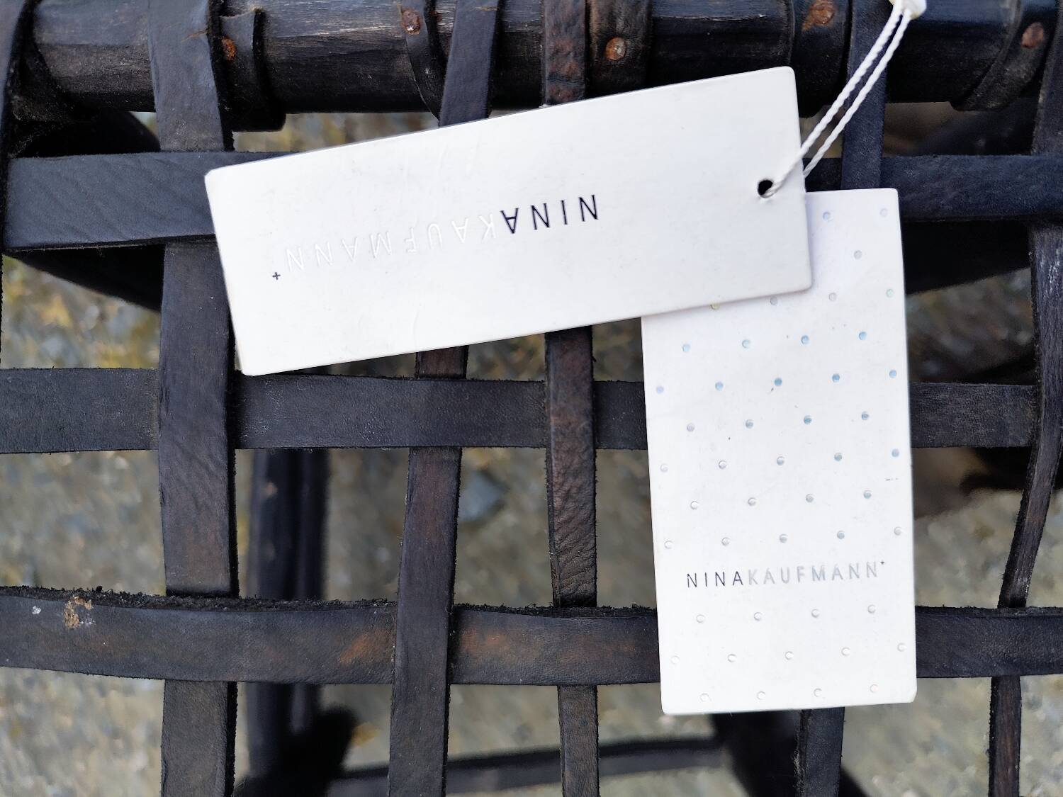 5 blackened wooden stools with woven leather seats by Nina Kaufmann