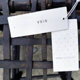 5 blackened wooden stools with woven leather seats by Nina Kaufmann